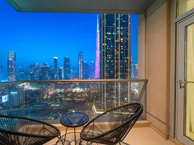 a balcony with chairs and a view of the city at Burj Views 3 min from Dubai Mall Luxury DownTown Residence in Dubai
