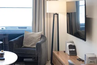 a living room with a chair and a lamp at New Studio in Business Bay with private Jacuzzi in Dubai
