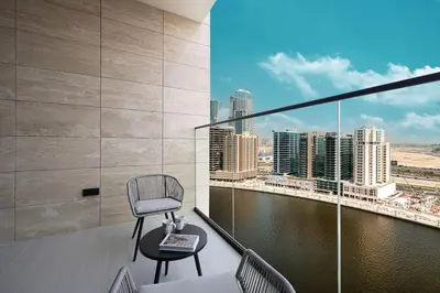 a chair on a balcony with a view of the city at New Studio in Business Bay with private Jacuzzi in Dubai