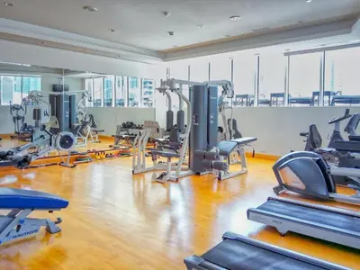 a gym with treadmills and machines in a room at Trident Bayside - Beautiful Two Bed in the Marina in Dubai