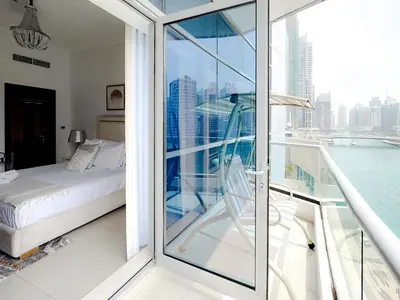 a balcony with a bed and a view of the city at Full Marina view, mins to JBR beach, Ain Dubai, Palm in Dubai