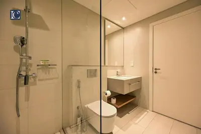 a bathroom with a shower and a toilet and a sink at Luxury Escapes - Exquisite 3BR plus Maid, Full Sea View in JBR in Dubai