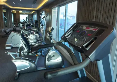 a row of exercise bikes in a gym at 1Bedroom Apartment with Portable bed in Living Area in Dubai