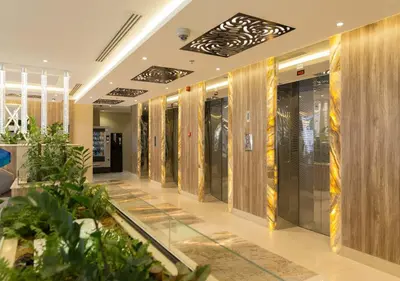 a lobby with a row of elevators in a building at 1Bedroom Apartment with Portable bed in Living Area in Dubai
