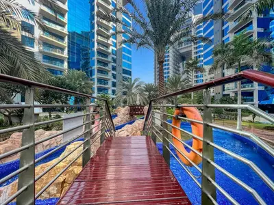 a bridge over a swimming pool in a city at Family Beach Home 3BR on Palm Jumeirah with Pool in Dubai