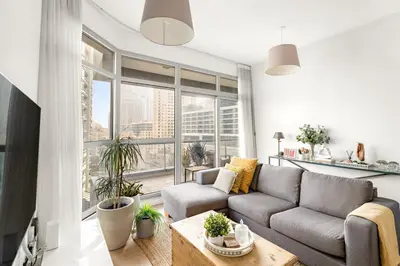 a living room with a couch and a large window at Dubai Marina Luxury 2BR with Pool, Gym & Near JBR Beach, Metro in Dubai