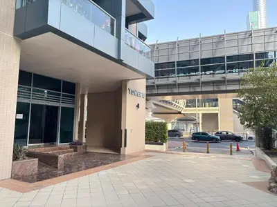 an office building with a parking lot in front of it at Dubai Marina Luxury 2BR with Pool, Gym & Near JBR Beach, Metro in Dubai
