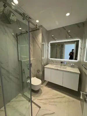 a bathroom with a shower and a toilet and a sink at 5 Star Luxury 3BR Apartment on The Palm with Huge Pool and Beach in Dubai