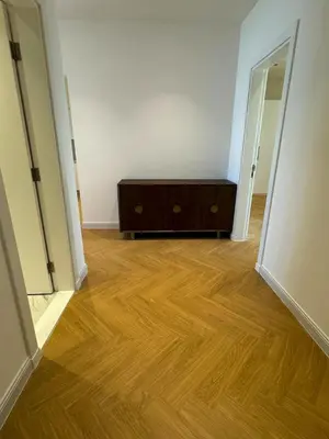 an empty room with a dresser and a wooden floor at 5 Star Luxury 3BR Apartment on The Palm with Huge Pool and Beach in Dubai