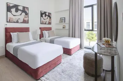 a hotel room with two beds and a window at Frank Porter - Murooj Al Furjan West in Dubai