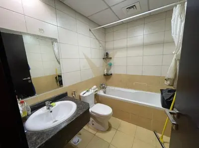 a bathroom with a sink and a toilet and a tub at Luxury hub in Dubai