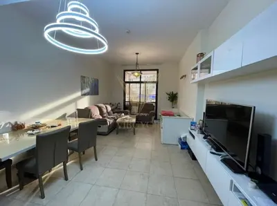 a kitchen and living room with a table and chairs at Luxury hub in Dubai