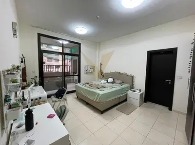 a bedroom with a bed and a desk and a window at Luxury hub in Dubai