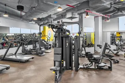 a gym with several treadmills and machines at Luxury Apt DIFC, XL Layout, Pool, Gym, Skyline View in Dubai