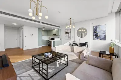 a living room with a couch and a table at Luxury Apt DIFC, XL Layout, Pool, Gym, Skyline View in Dubai