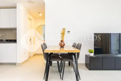 a dining room table and chairs in a kitchen at Bloomfields 1br Elegant Escape The Pulse in Dubai