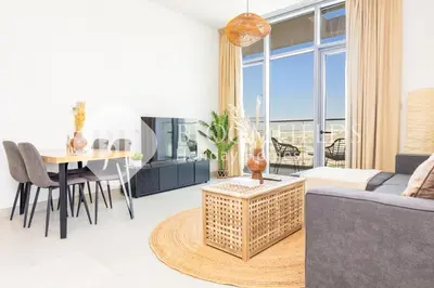 a living room with a couch and a table at Bloomfields 1br Elegant Escape The Pulse in Dubai