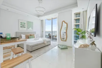 a living room with a couch and a table at Cozy Studio 7 Minutes From Dubai Mail in Dubai