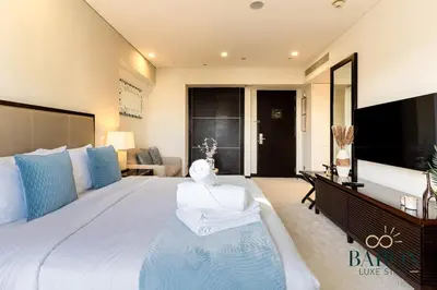 a large bedroom with a large bed and a desk at The Prestige in Dubai