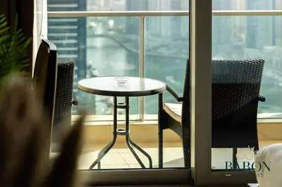 a table and chairs in front of a window at The Prestige in Dubai