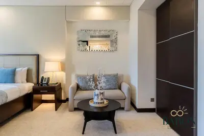 a hotel room with a bed and a couch and a table at The Prestige in Dubai