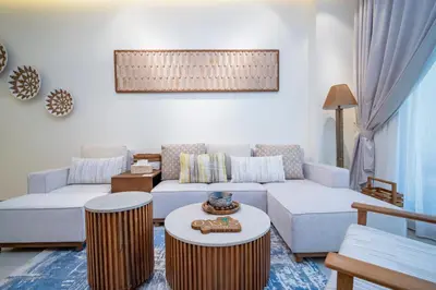 a living room with a couch and a table at Oasis by Tarrab in Dubai