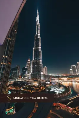a view of the shibuya tower at night at Stylish 2-Bedroom Luxury Stay in Downtown Dubai with Burj Khalifa & Fountain Views in Dubai