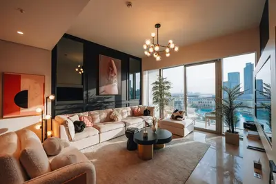 a living room with a couch and a table at Stylish 2-Bedroom Luxury Stay in Downtown Dubai with Burj Khalifa & Fountain Views in Dubai