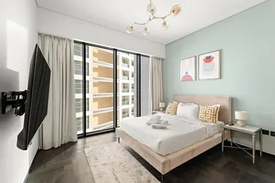 a bedroom with a bed and a large window at Chic 2BR Close to Burj Khalifa, Dubai Mall & Creek in Dubai