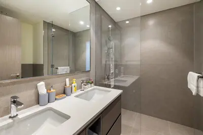 a bathroom with a sink and a mirror at Grande 2BR Apartment with Burj Khalifa & Fountain Views in Dubai