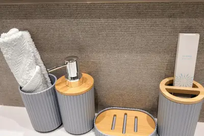 a bathroom with two trash cans and a toothbrush at Grande 2BR Apartment with Burj Khalifa & Fountain Views in Dubai