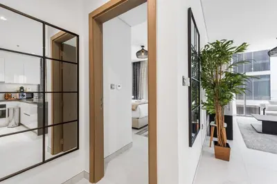a hallway with a door leading to a living room at Luxurious 1 BR in District One Beach Access in Dubai