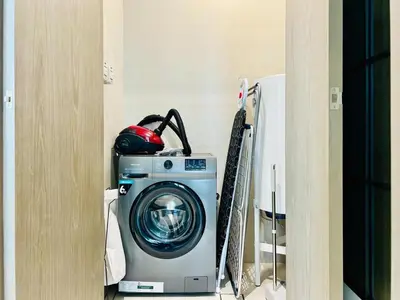 a washing machine in a corner of a room at Luxurious 1 BR in District One Beach Access in Dubai