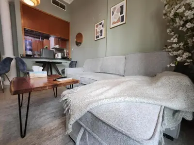 a living room with a couch and a table at Luxury Apartment- 5 min Walking Distance Beach and 3 minutes walking distance Metro in Dubai