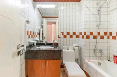 a bathroom with a sink and a tub and a toilet and a bath tub at Luxury Apartment- 5 min Walking Distance Beach and 3 minutes walking distance Metro in Dubai