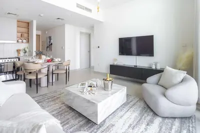 a living room with a couch and a table at Frank Porter - Creek Crescent Tower 1 in Dubai
