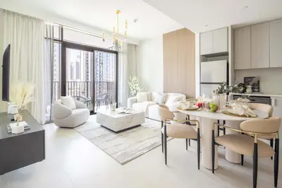 a living room with a table and chairs and a living room at Frank Porter - Creek Crescent Tower 1 in Dubai