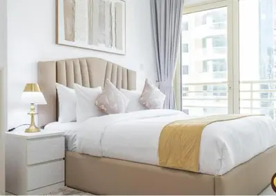 a white bedroom with a large bed with a window at Dubai Marina-2Bedroom-3 balcony with view-direct acces to Marina Promenade in Dubai