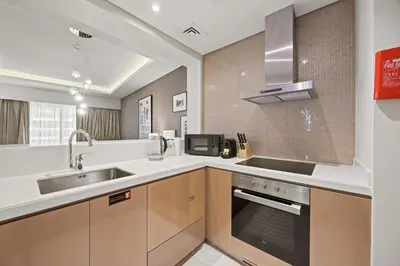 a kitchen with a sink and a stove at Elite Escapes - Glamorous 1BR DAMAC Paramount B in Dubai