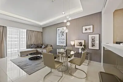 a living room with a table and a couch at Elite Escapes - Glamorous 1BR DAMAC Paramount B in Dubai