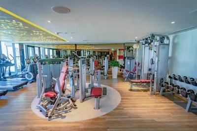 a gym with a lot of equipment in a room at Elite Escapes - Glamorous 1BR DAMAC Paramount B in Dubai