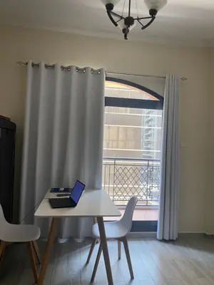 a laptop sitting on a table in front of a window at Dorm&GO in Dubai