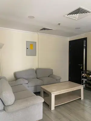 a living room with a couch and a coffee table at Dorm&GO in Dubai