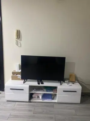 a white entertainment center with a flat screen tv on it at Dorm&GO in Dubai