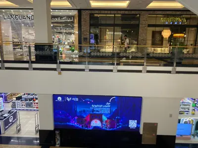 a large flat screen tv in a shopping mall at Dorm&GO in Dubai