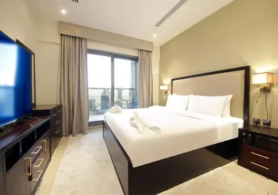 a bedroom with a large bed and a large window at Breathtaking Views from a H-Floor Studio in Dubai in Dubai