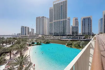 a pool in the middle of a city with tall buildings at Modern 2BR Apartment - Vida Residences Creek Beach - Creek Beach Access in Dubai