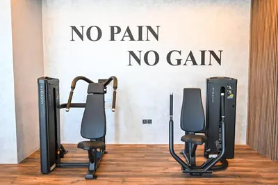 a gym with two exercise equipment in front of a wall at Modern Studio with Balcony and Pool Access - Holiday Boulevard in Dubai