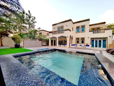 a large swimming pool in front of a house at Signature 7-bedroom Villa Marina in Dubai
