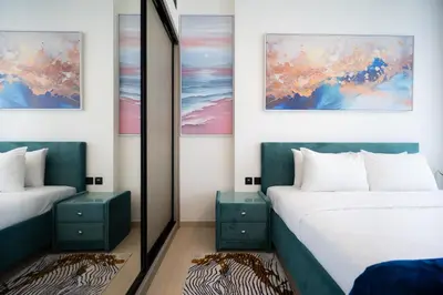 a bedroom with two beds and a mirror at Cozy NEW brand 1BR at JVC Binghatti Corner in Dubai